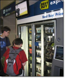 The Draper boys check out a high tech vending machine in the Minneapolis airport.